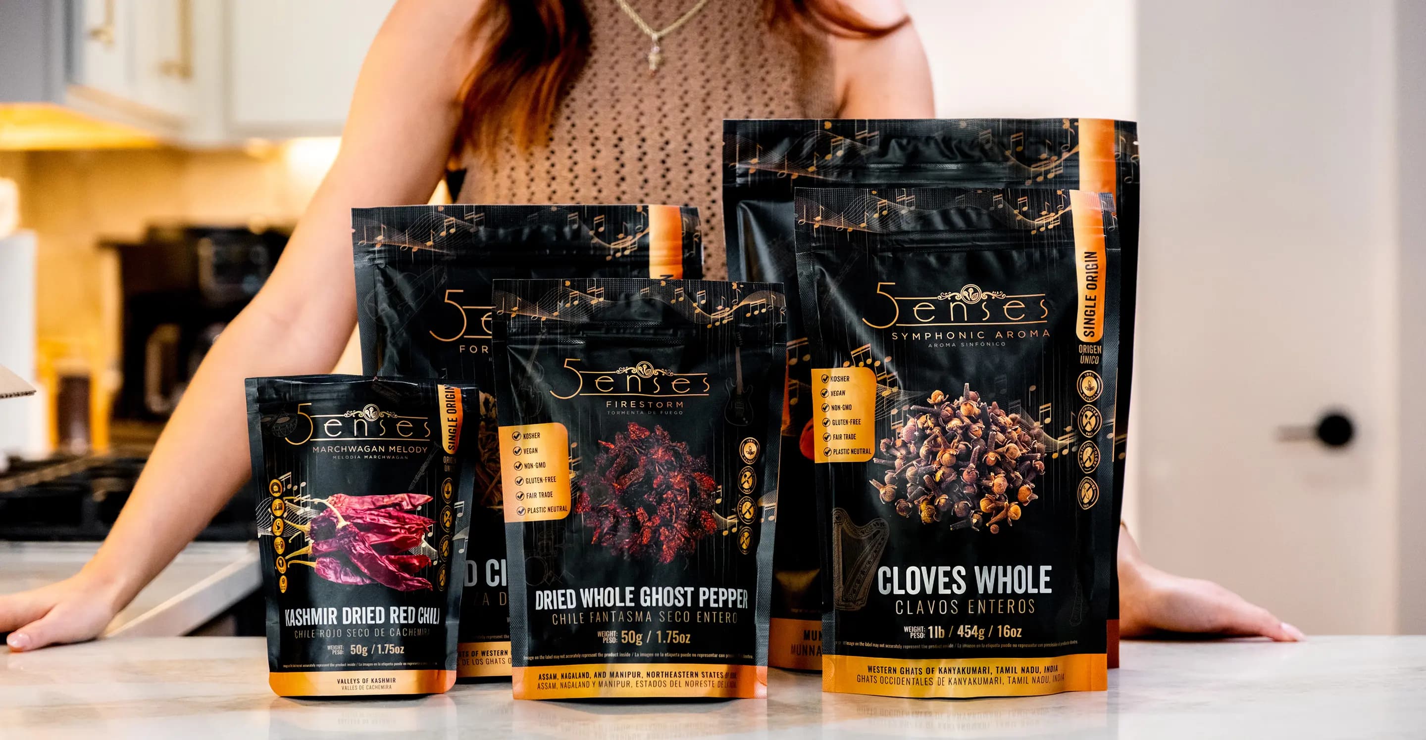 A wide, top down shot of 5Senses pouches laid flat on a table, with loose spices scattered naturally around them.