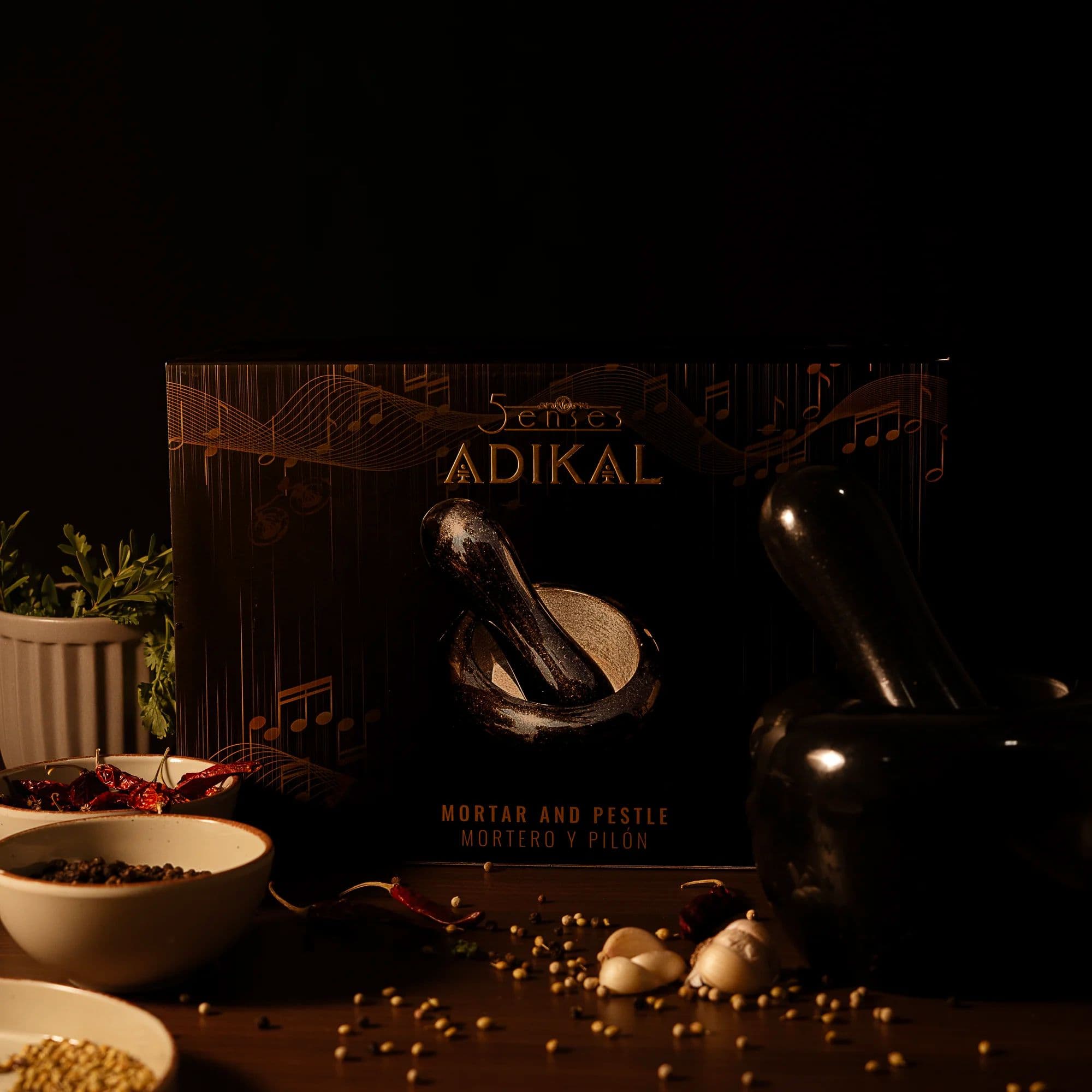 5Senses ADIKAL polished black granite mortar and pestle beside its musical-themed luxury gift packaging